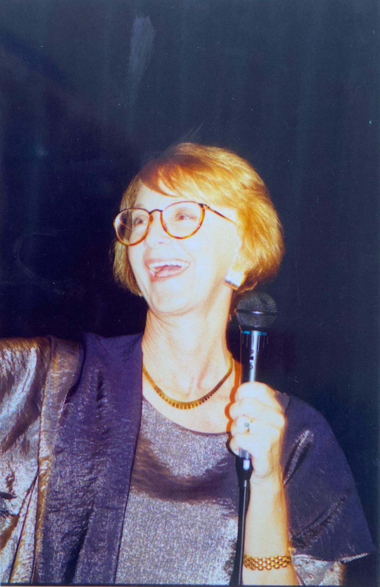 Speaker with a microphone presenting at a workshop